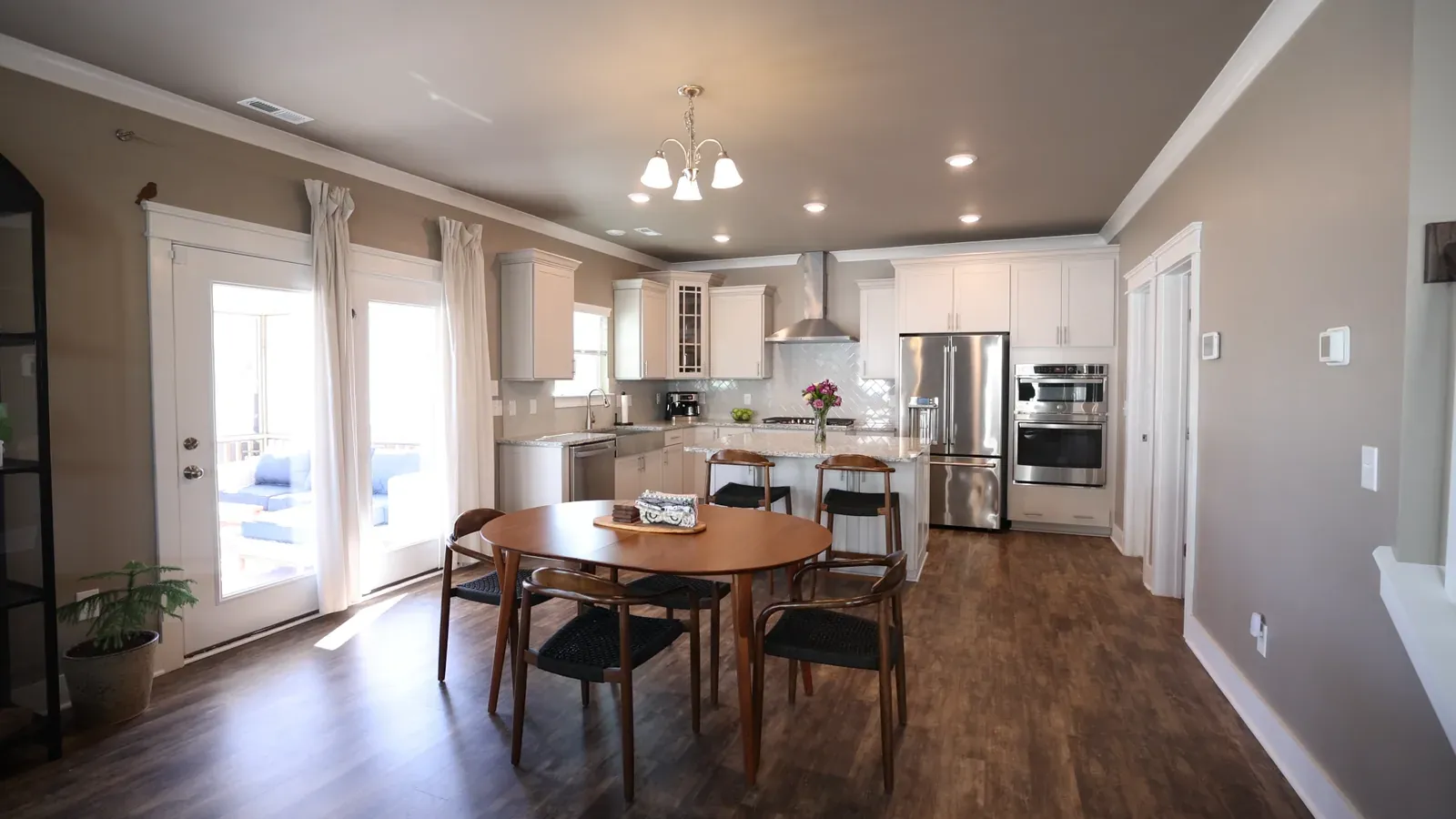 A finished open-plan kitchen and dining room with new cabinetry and flooring