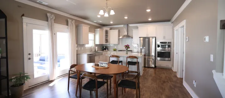 A finished open-plan kitchen and dining room with new cabinetry and flooring